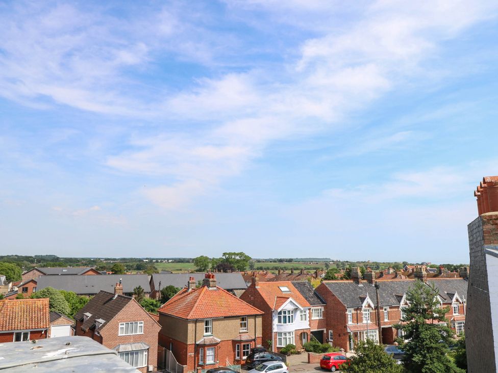 A view of houses and greenery from a rooftop at Skylark in Southwold