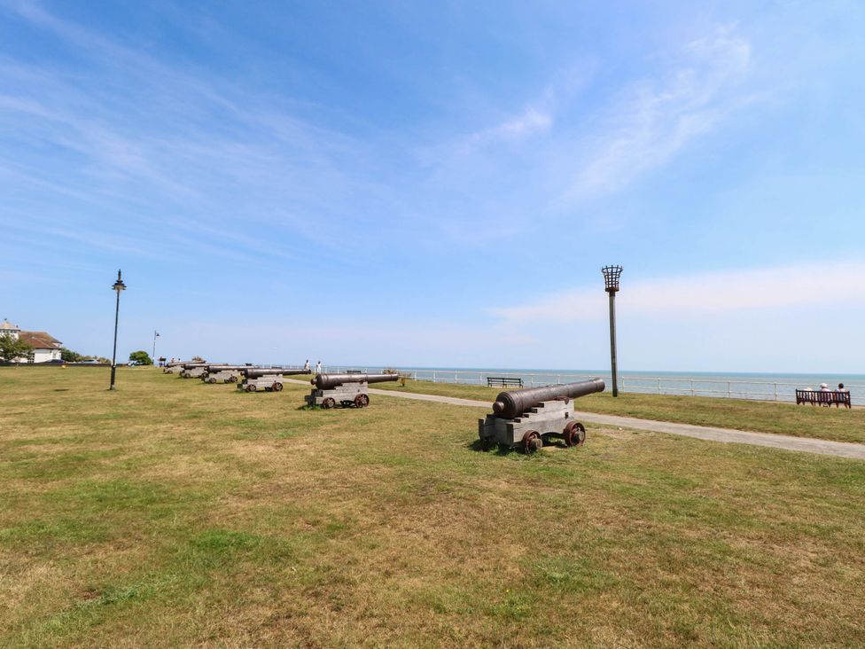 Cannons and benches on a grassy area near the sea at Skylark in Southwold