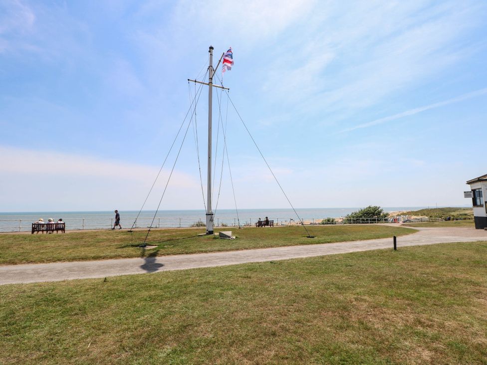 An outdoor area with a flagpole and a view of the sea at Skylark Southwold