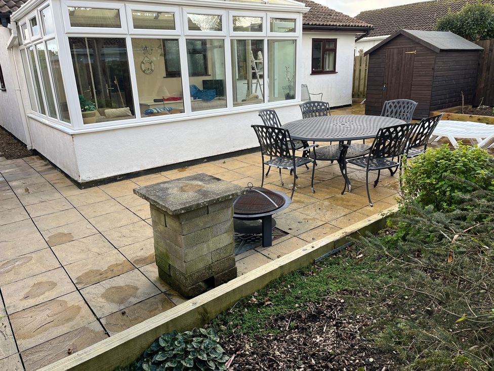 An outdoor patio with a dining table and chairs at Beachcombers in St Merryn