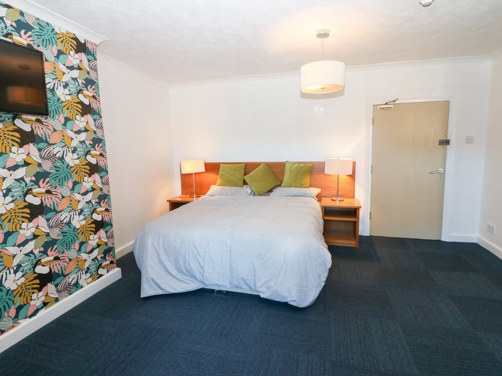 A bedroom with a bed and television at Bedroom 1 