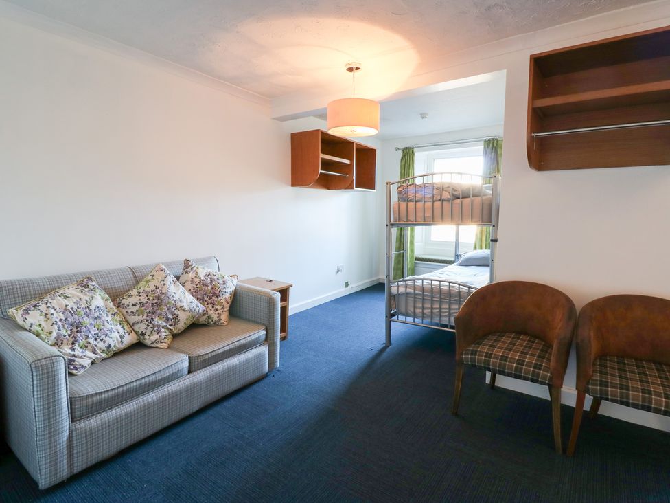 A bedroom with a sofa and bunk bed at Bedroom 1