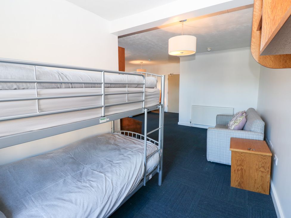 A bedroom with a bunk bed and a sofa at Bedroom 1