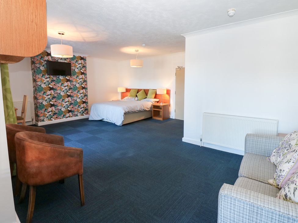 A bedroom with a bed and sofa at Bedroom 1