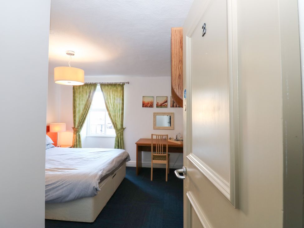 A bedroom with a bed and a desk at Bedroom 2