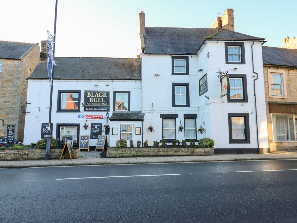 A pub and restaurant building with signs at Black Bull in 
