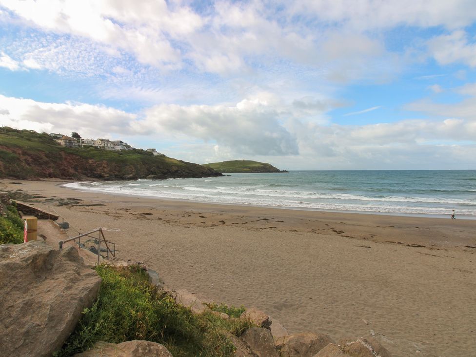 A beach view with hills and ocean at 7 Beachdown, Challaborough