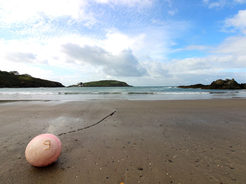 A buoy on the beach with sea and sky at 7 Beachdown in Challaborough
