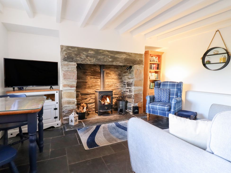 A living room with a fireplace and television at Ael Y Bryn Ffestiniog
