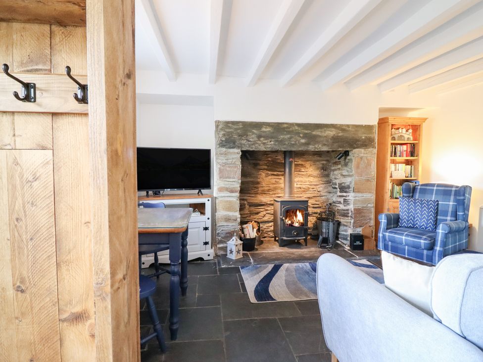 A living room with a fireplace and a TV at Ael Y Bryn in Ffestiniog