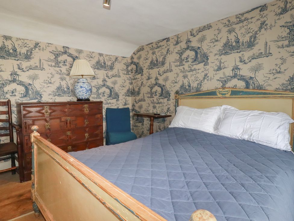 A bedroom with a bed and dresser at Penvar in Truro