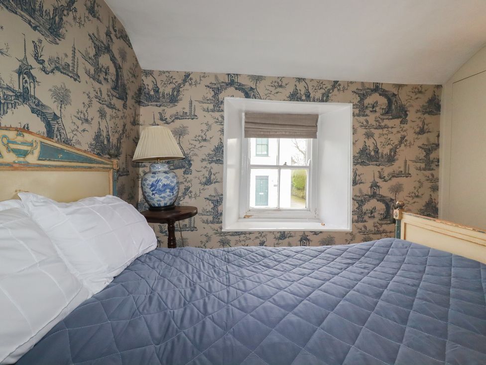 A bedroom with a bed and window at Penvar in Truro
