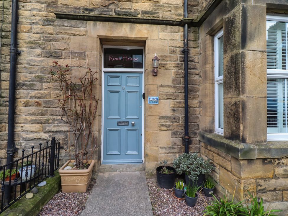 An entrance with a blue front door at Rose House in Alnmouth