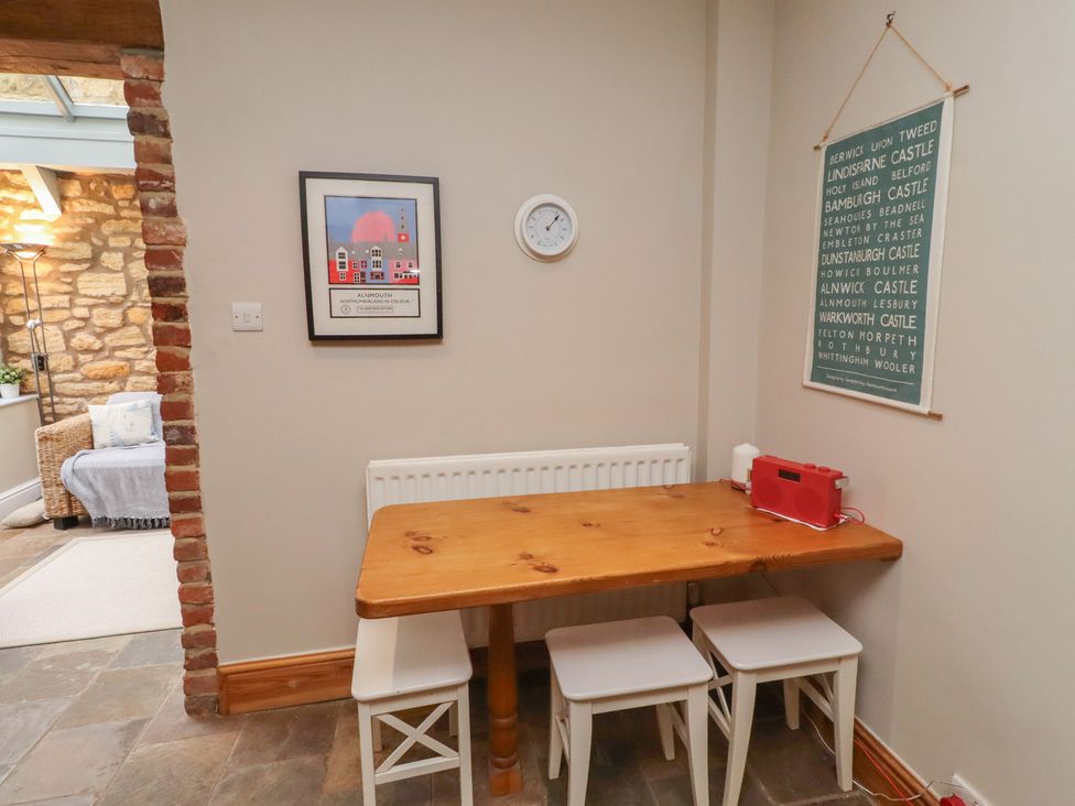 A dining room with a table and chairs at Rose House in Alnmouth