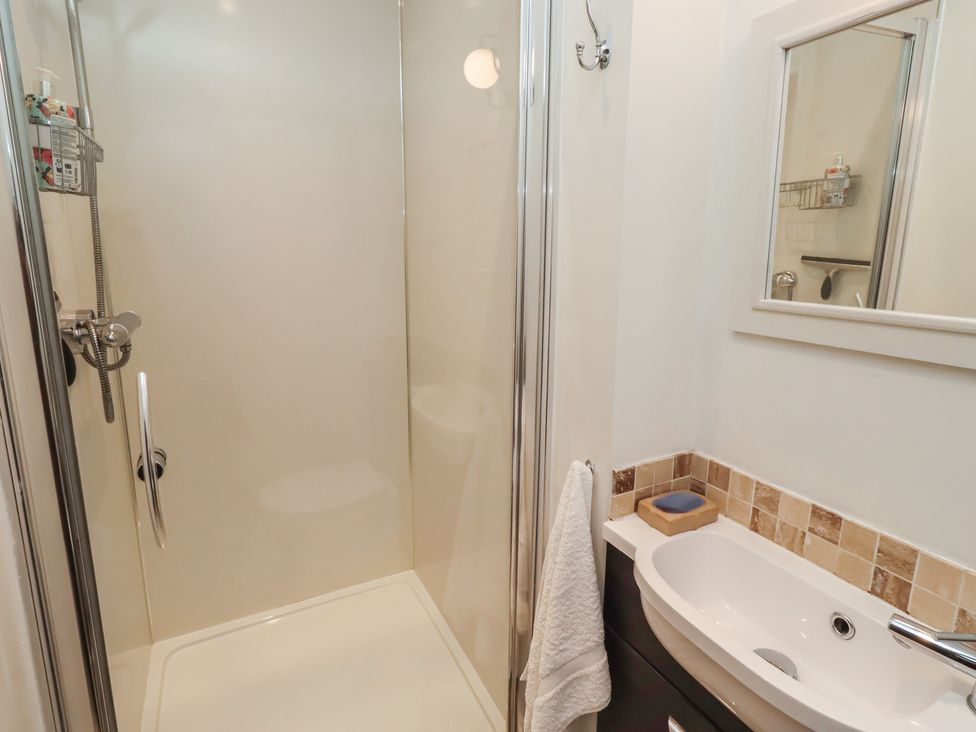 A bathroom with a shower and sink at Rose House in Alnmouth