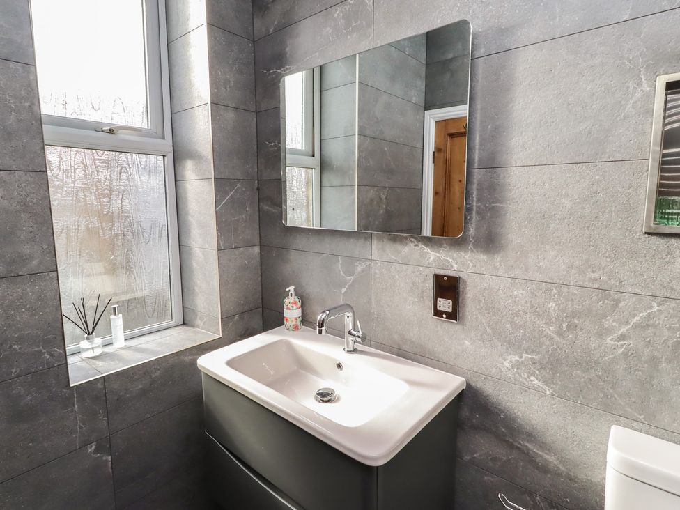 A bathroom with a sink and mirror at Rose House Alnmouth
