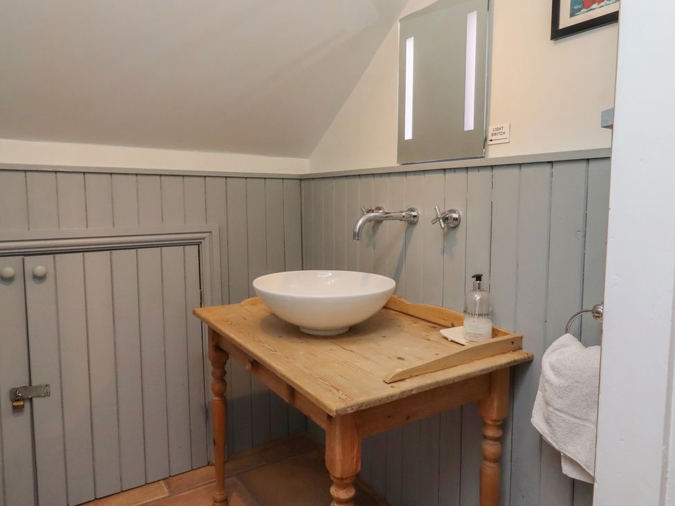 A bathroom with a sink and faucet at Rose House Alnmouth