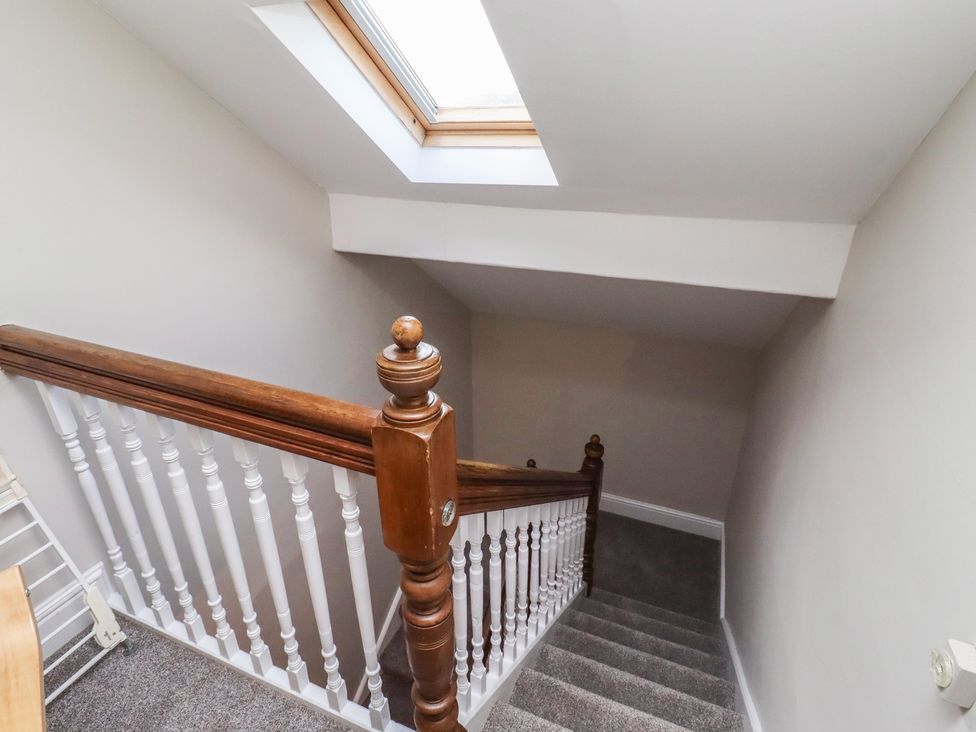 A staircase with a handrail and a skylight at Rose House in Alnmouth