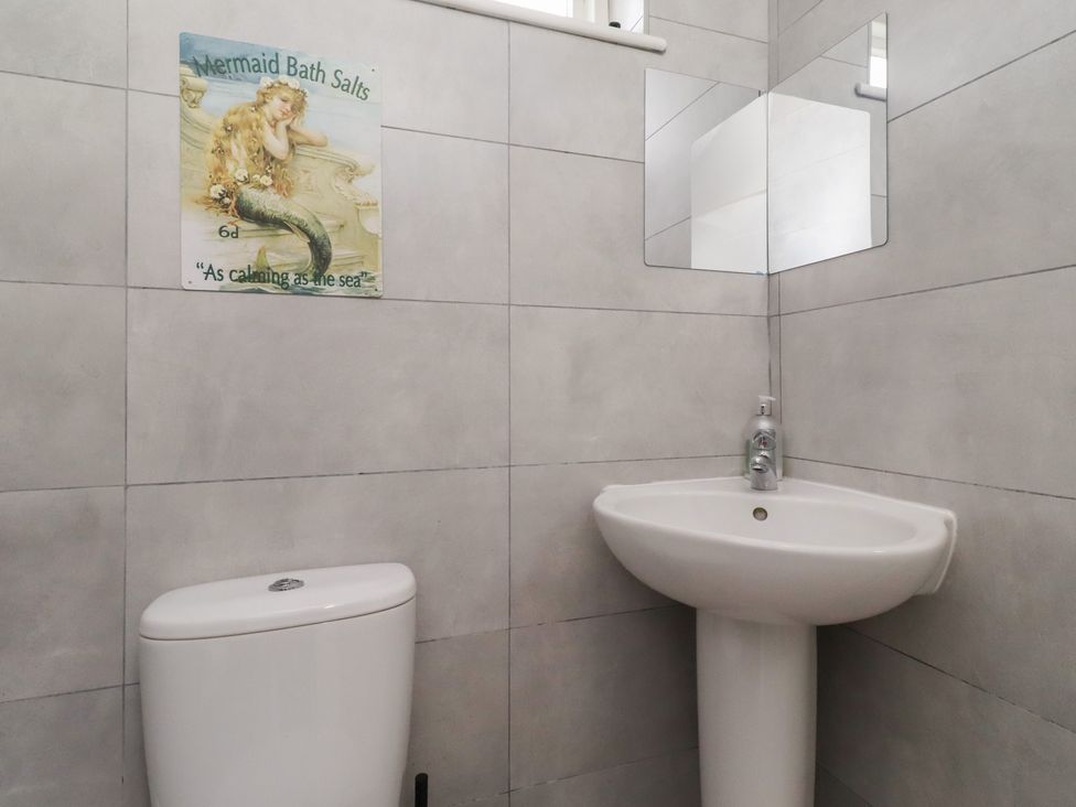 A bathroom with a toilet and sink at Rose House Alnmouth