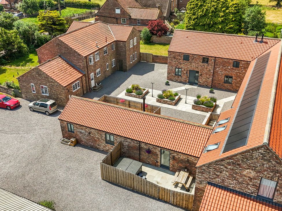 An outdoor view of buildings and courtyard at The Hay Barn in Thirsk