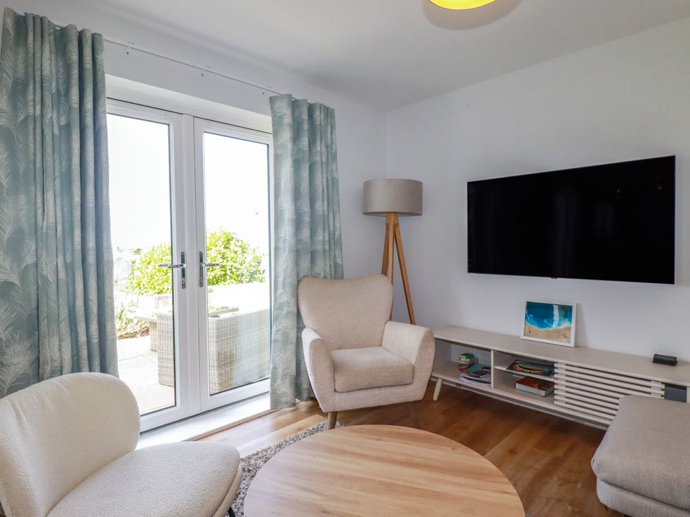 A living room with a television and seating area at Lavender House in Crantock