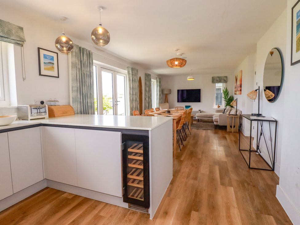 A kitchen with dining area and living space at Lavender House in Crantock