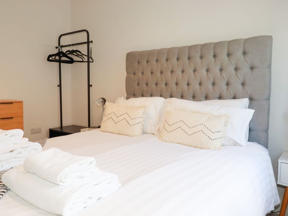 A bedroom with a bed and bedside table at Lavender House in Crantock