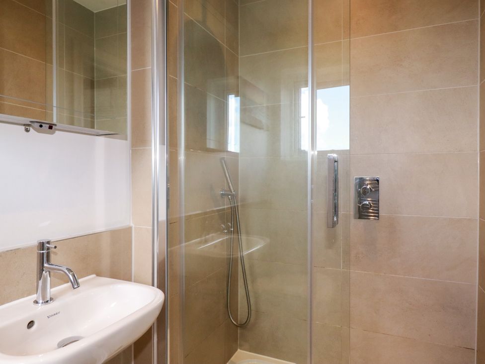 A bathroom with a shower and sink at Lavender House in Crantock