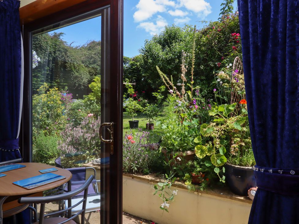 A view of a garden from a dining room window at Turnpike Lodge in Brixham