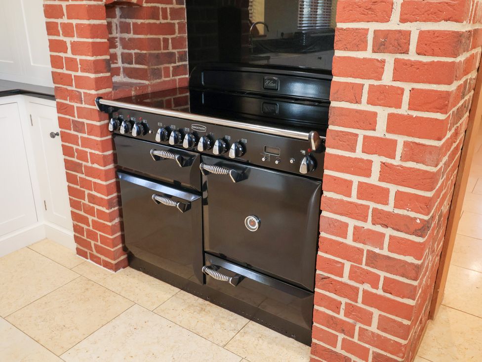 A stove with an oven in a kitchen at The Stables at Hall Barn Wattisfield near Walsham-Le-Willows