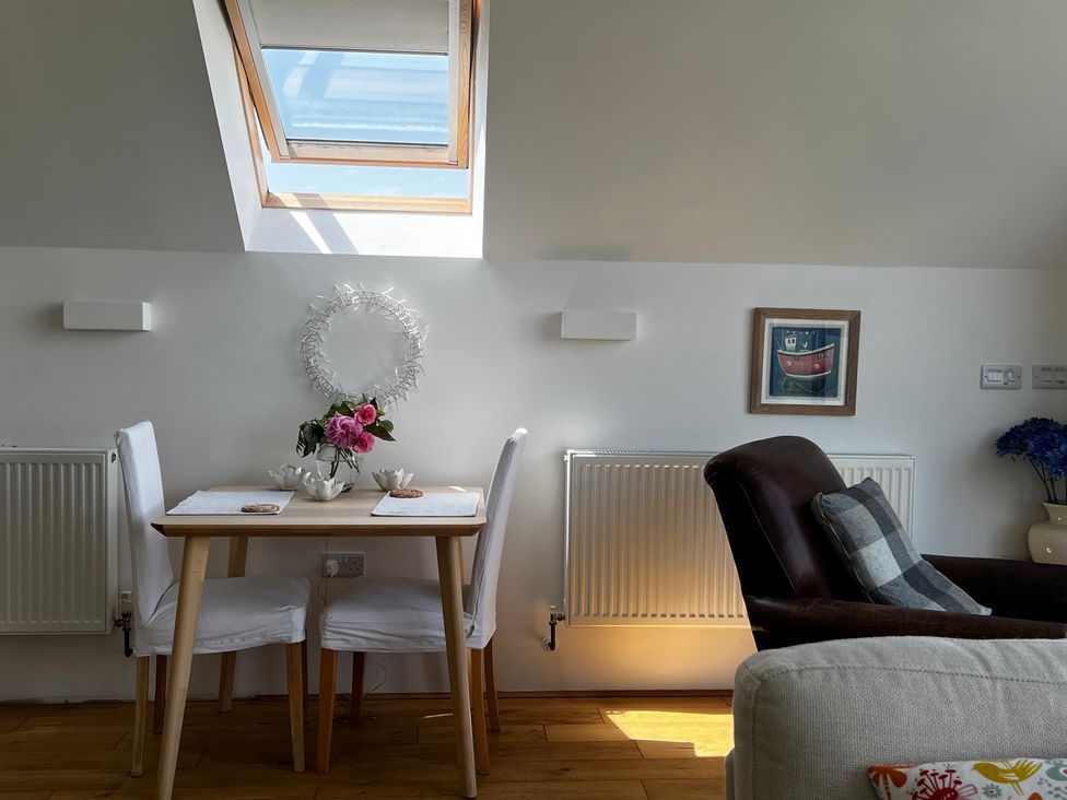 A dining area with a table and chairs at Spires Playing Place near Carnon Downs