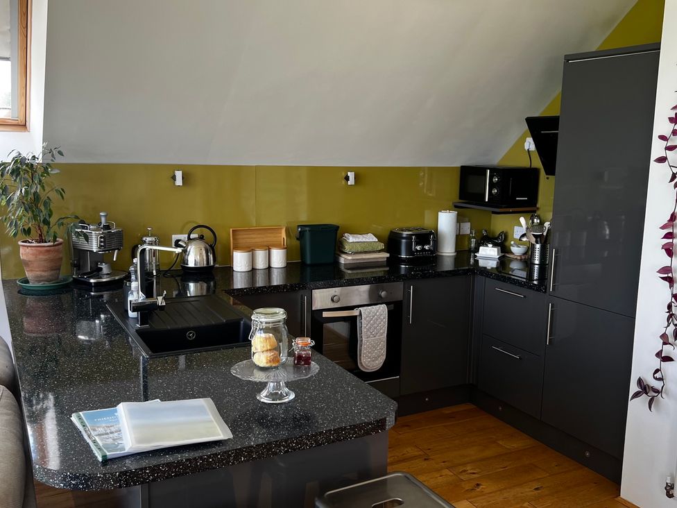 A kitchen with a sink, kettle, toaster, and storage at Spires in Playing Place near Carnon Downs