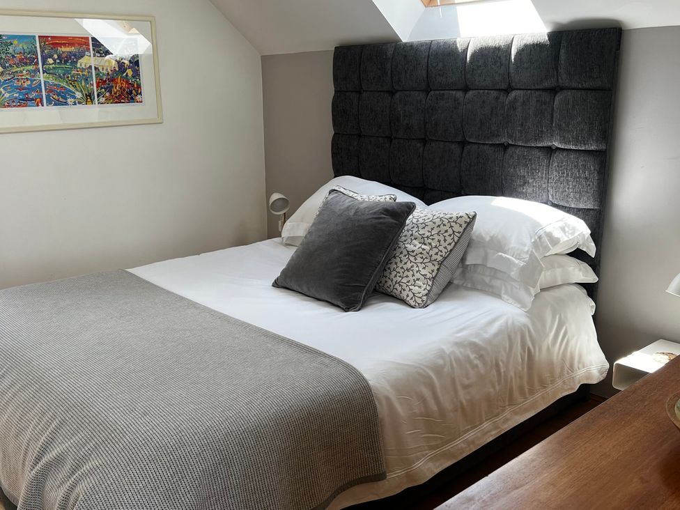 A bedroom with a bed and decorative pillows at Spires Playing Place near Carnon Downs