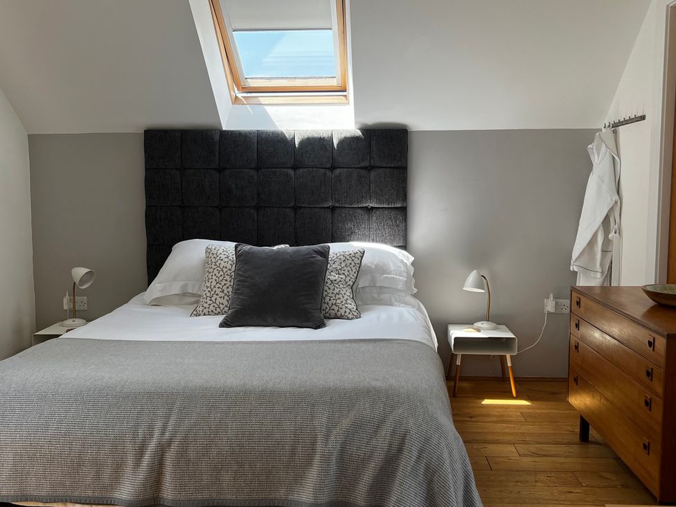 A bedroom with a bed and side table at Spires in Playing Place near Carnon Downs
