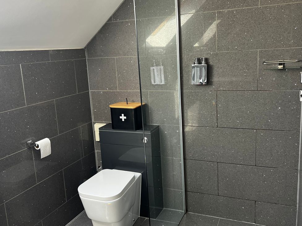 A bathroom with a toilet and shower at Spires in Playing Place near Carnon Downs
