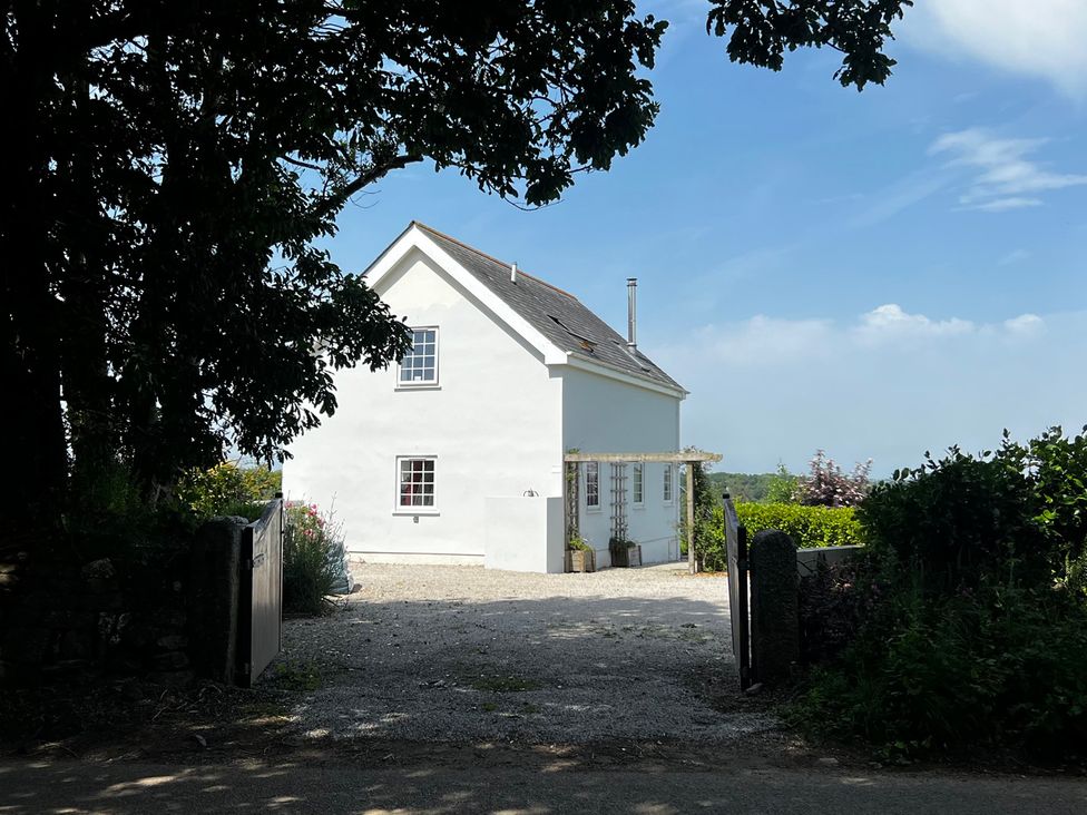 A house with a gate and driveway at Spires in Playing Place near Carnon Downs