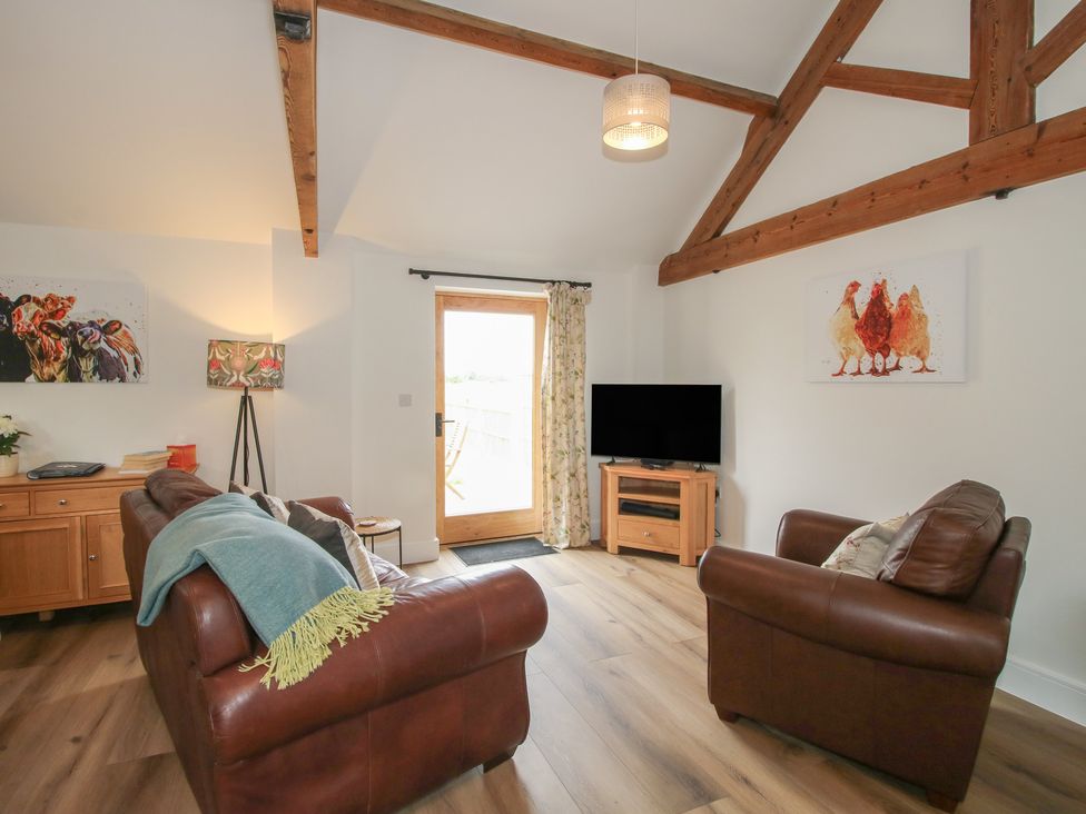 A living room with a door leading outside at Oak Barn Northwood near Wem