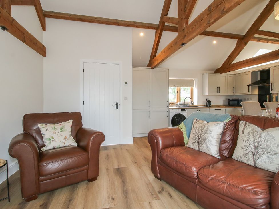 A living room with a sofa and armchair at Oak Barn near Wem