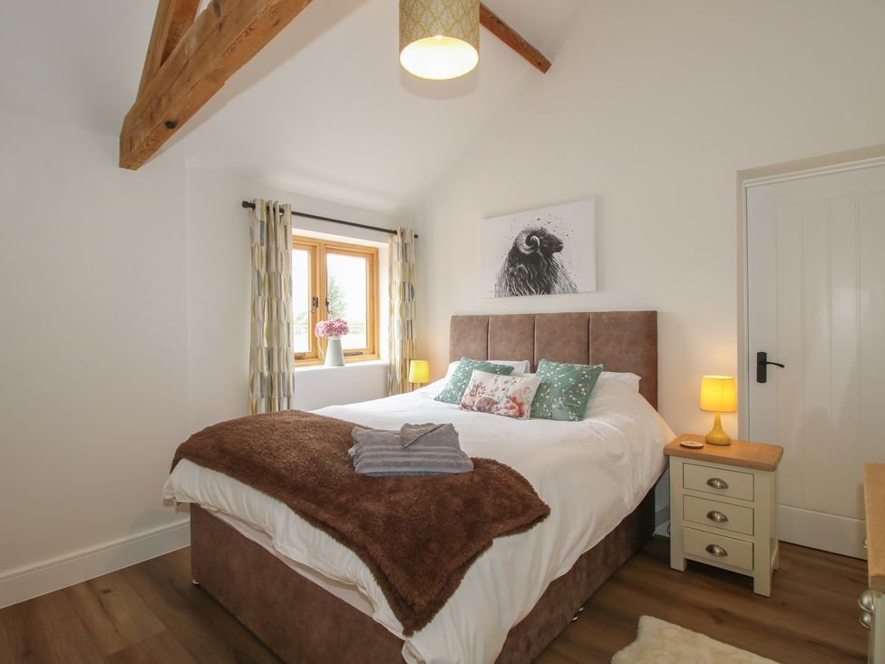 A bedroom with a bed and nightstand at Oak Barn Northwood near Wem