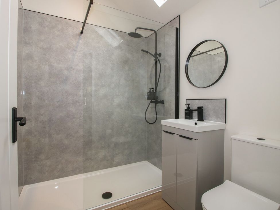 A bathroom with a shower, toilet, and sink at Oak Barn in Northwood near Wem