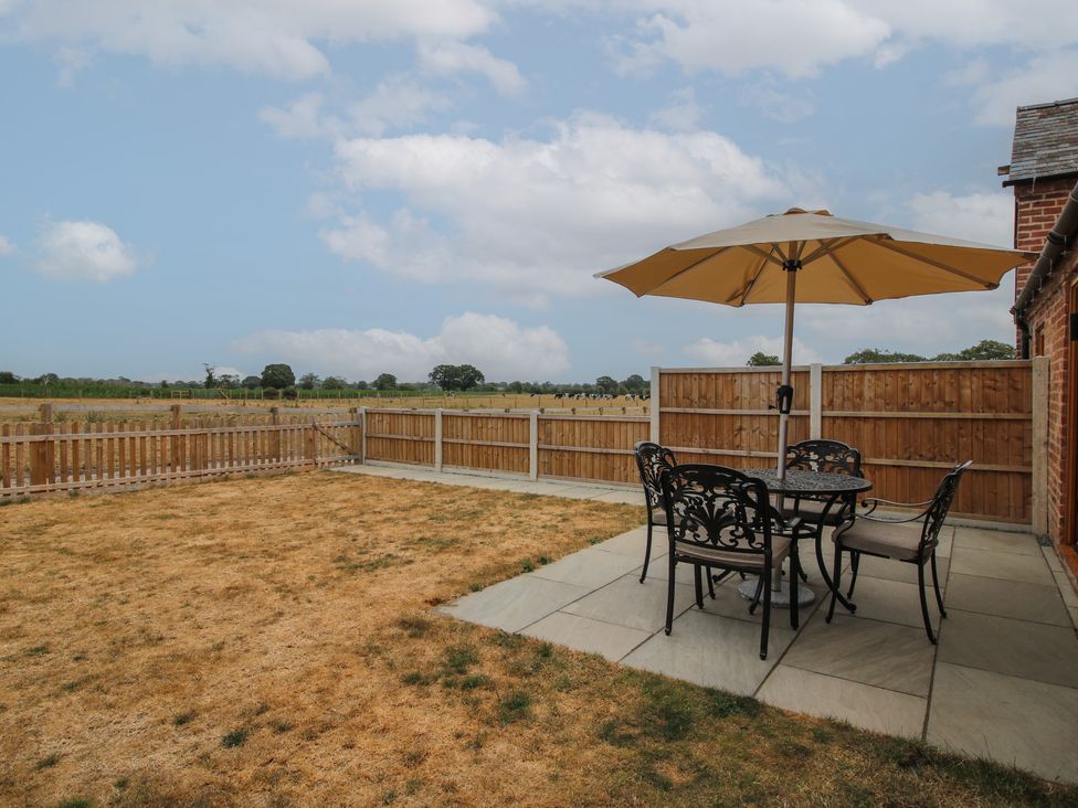 A garden with a table and chairs at Oak Barn Northwood near Wem