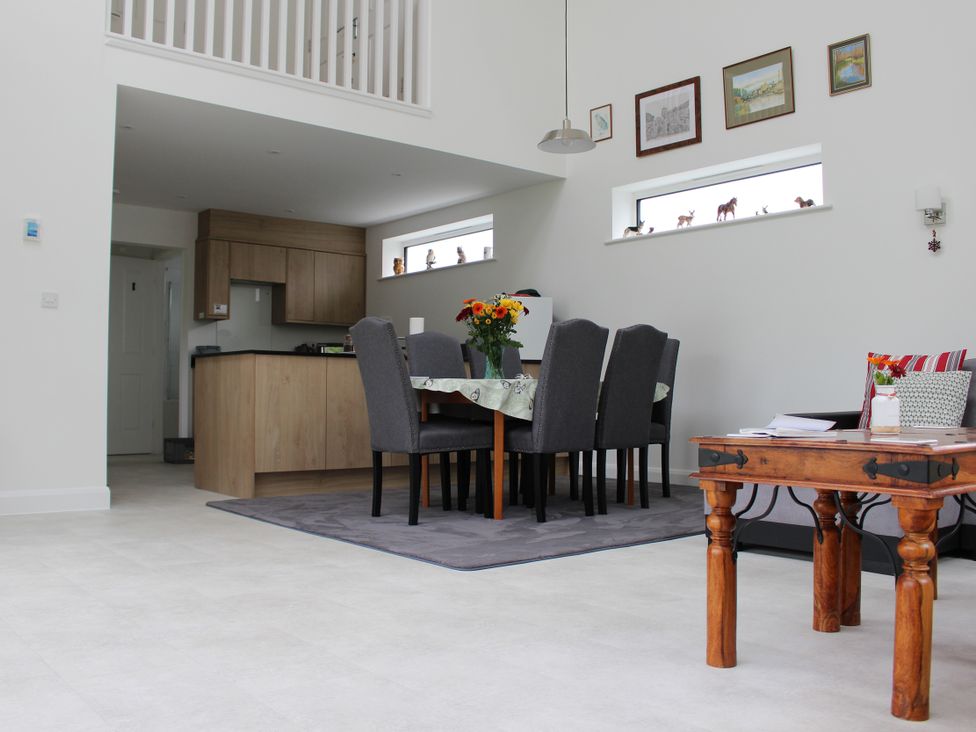 A dining room with a table and chairs at Narracott Down in South Molton