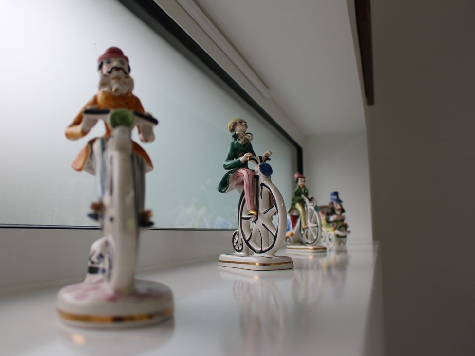 Figurines on bicycles displayed on a shelf at Narracott Down in South Molton