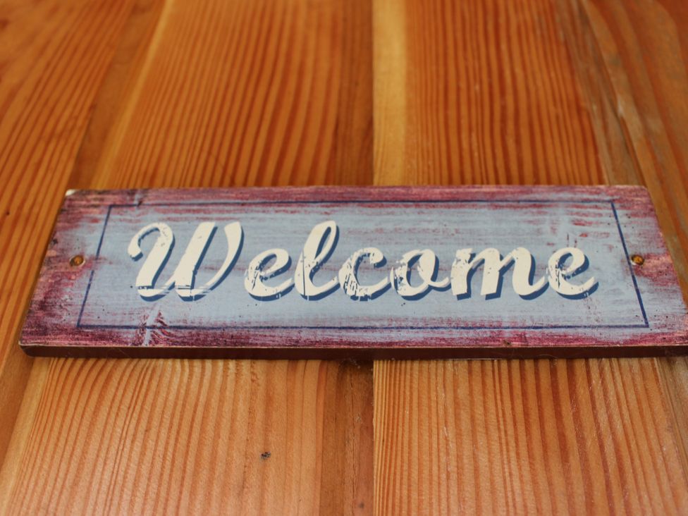 A welcome sign mounted on wood at Narracott Down in South Molton