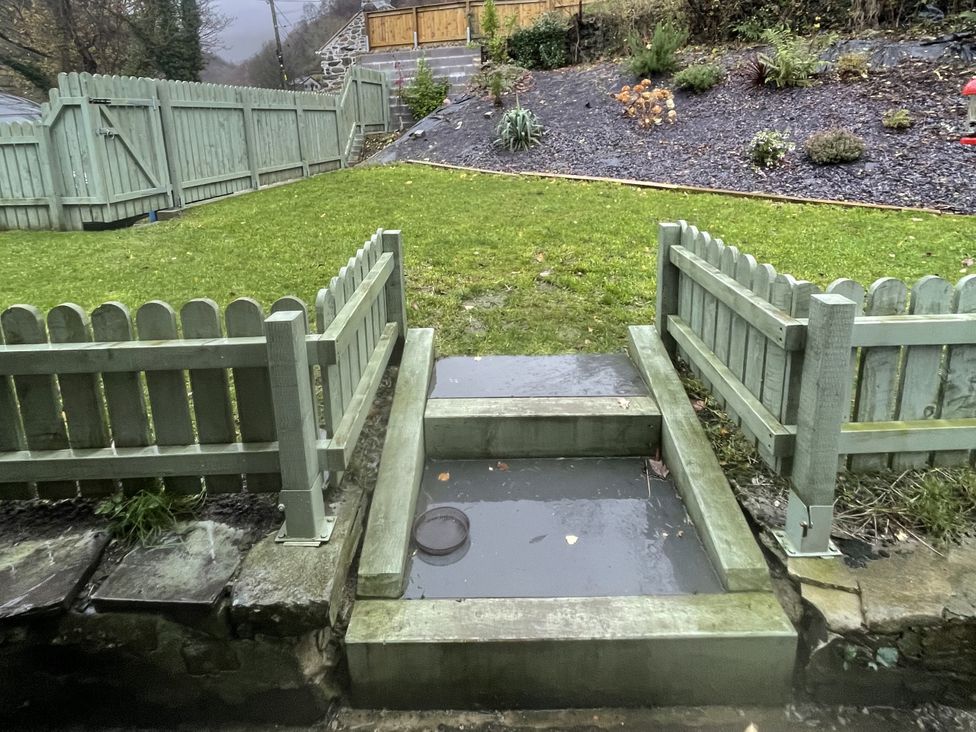 A garden with steps and a fence at Old Chapel House Abergwyngregyn near Llanfairfechan