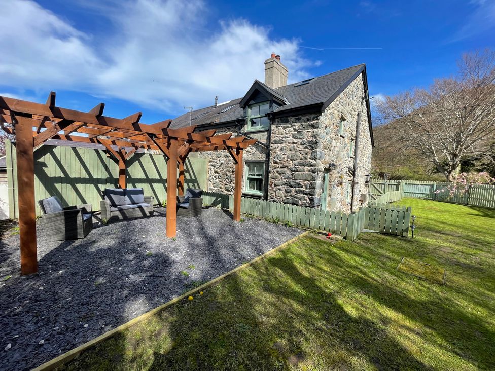 A garden with a pergola and chairs at Old Chapel House Abergwyngregyn near Llanfairfechan