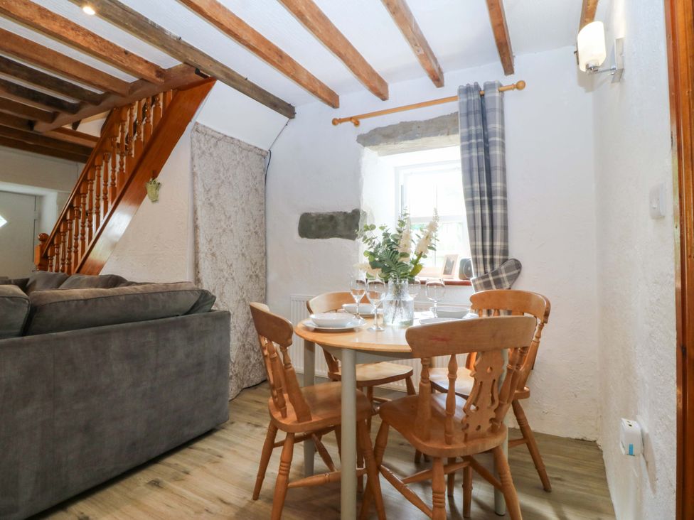 A dining area with a table and chairs at Old Chapel House Abergwyngregyn near Llanfairfechan