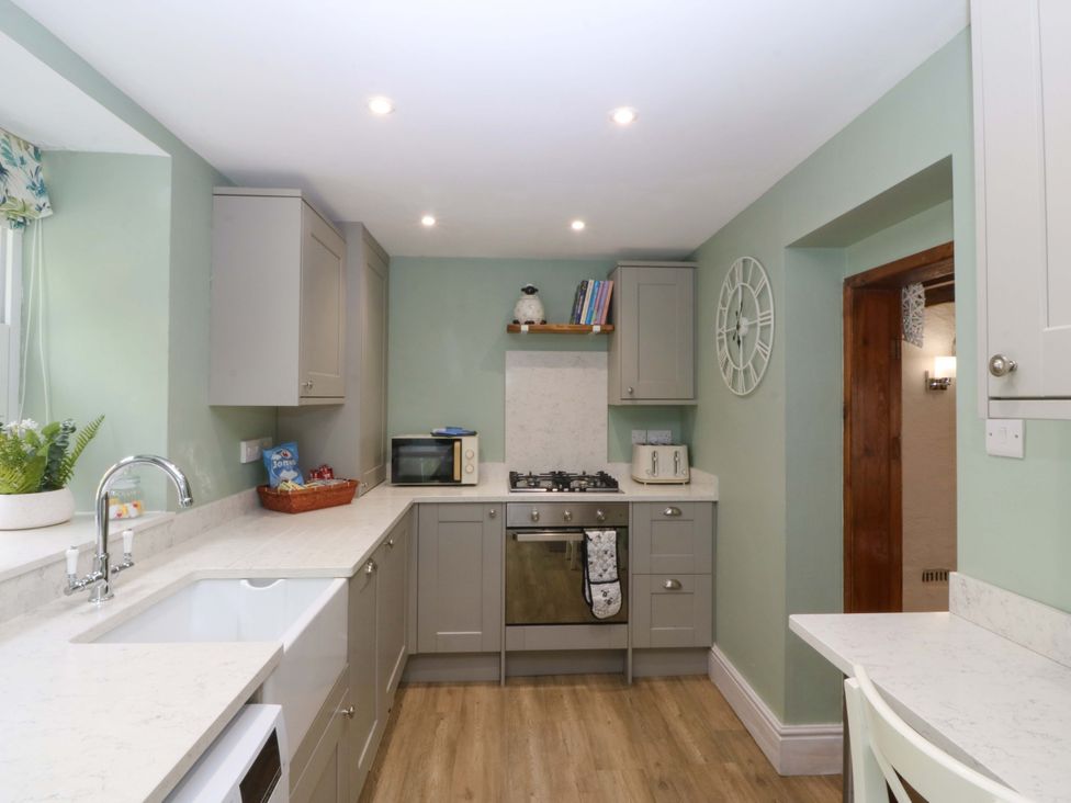 A kitchen with a sink and stove at Old Chapel House Abergwyngregyn near Llanfairfechan