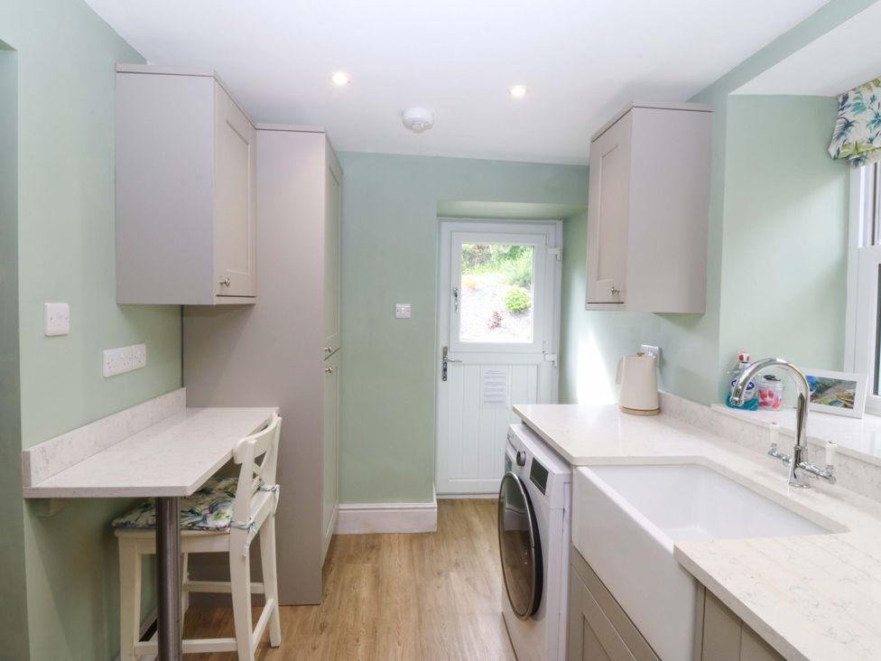 A kitchen with a washing machine and sink at Old Chapel House Abergwyngregyn near Llanfairfechan