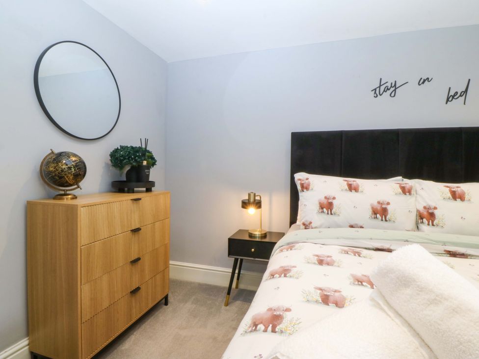 A bedroom with a bed and nightstand at Old Chapel House Abergwyngregyn near Llanfairfechan